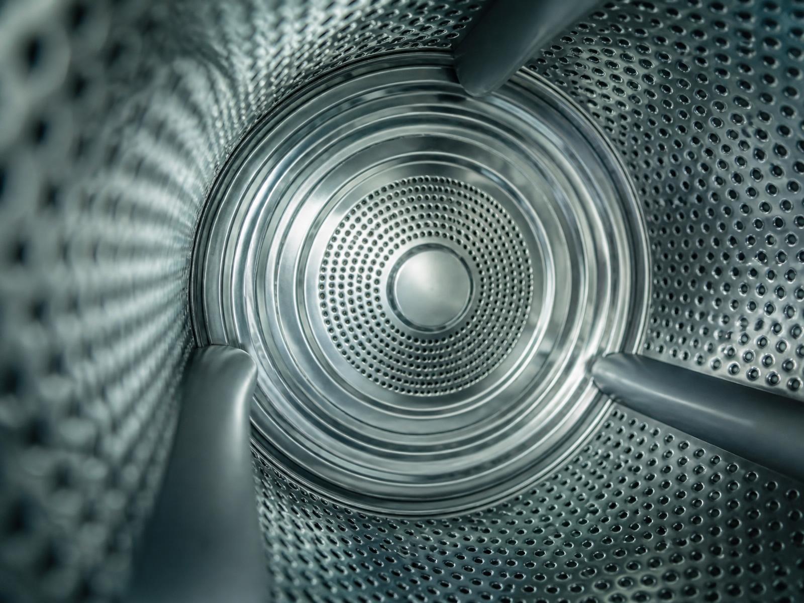 Macro photograph inside a stainless steel washing machine drum